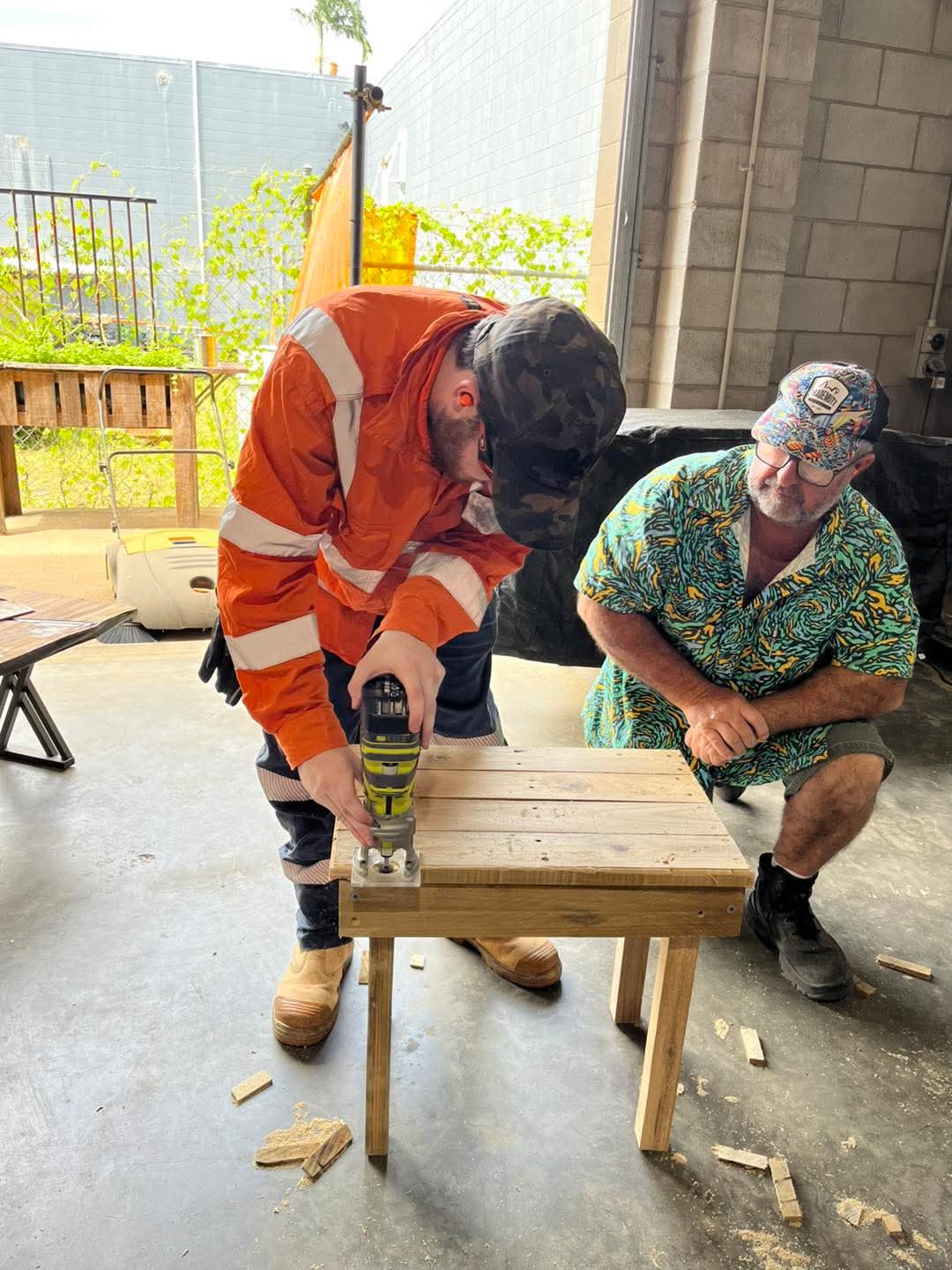 Participant learning practical carpentry skills in a workshop